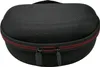 A black hard-shell case for headphones with a red zipper. Produktbild-Vorschau