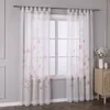 A window with sheer curtains featuring a floral pattern. Produktbild-Vorschau