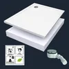 A white shower tray with a white styrofoam base and a white drain fitting are shown against a dark blue background. There are also four small icons in the bottom left corner. Produktbild-Vorschau