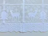 A close-up view of a white lace curtain with a Christmas theme, featuring deer and snowflakes. Produktbild-Vorschau