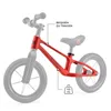 A red balance bike with gray wheels and handlebars, shown against a white background, with annotations indicating features. Náhled obrázku produktu