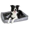 A border collie dog lying on a dog bed. Anteprima dell’immagine prodotto