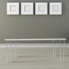 A minimalist interior scene featuring a white table with hairpin legs against a gray wall adorned with four white square picture frames. Náhled obrázku produktu