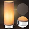 A table lamp with a fabric shade and a metallic base, shown with close-up details of the fabric texture and the base. Produktbild-Vorschau