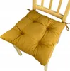 A yellow seat cushion on a wooden chair. Produktbild-Vorschau