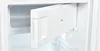 Interior view of a white refrigerator with a drawer slightly ajar. Produktbild-Vorschau
