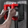 A person is using a concrete grinder on a wall. Podgląd zdjęcia produktu