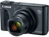 A black Canon PowerShot SX740 HS camera is shown from the front-left angle against a white background. Produktbild-Vorschau
