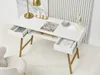 A white desk with gold legs, featuring open drawers, a laptop, a book, a lamp, and a mirror. Voir les images du produit
