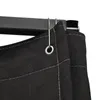 A close-up view of a black fabric curtain with grommets hanging from a dark metal rail. Produktbild-Vorschau