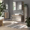A modern bathroom with a vanity, sink, and storage units, decorated with plants and a rug. Anteprima dell’immagine prodotto
