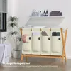 A laundry basket with four compartments in a bathroom setting. Anteprima dell’immagine prodotto