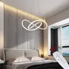 A modern bedroom with a pendant light above a bed. Produktbild-Vorschau