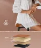 A woman is sitting on a bar stool, and below is a diagram showing the layers of the stool cushion. Produktbild-Vorschau