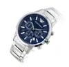 A close-up studio shot of a men's Emporio Armani watch with a blue dial and silver band, presented on a white background. Náhľad obrázku produktu