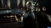 A man in a suit holding a silenced pistol, aiming it forward. Produktbild-Vorschau