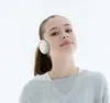 A young woman wearing headphones against a white background. Voir les images du produit