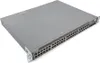 A network switch is shown from a three-quarter angle on a white background. Náhled obrázku produktu