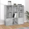 A concrete gray bookshelf with multiple compartments, some containing books and decorative items, placed on a wooden floor against a white wall. Náhled obrázku produktu