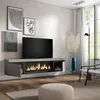A modern living room with a wall-mounted TV cabinet featuring an electric fireplace, artwork on the wall, and a floor lamp. Produktbild-Vorschau