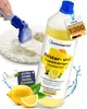 A bottle of cleaning concentrate is shown next to lemons and a cleaning tool on a rug. Produktbild-Vorschau