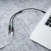 A close-up shot of an audio cable connecting to a laptop. Anteprima dell’immagine prodotto