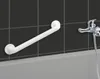 A white grab bar is mounted on a tiled wall above a bathtub, with a chrome faucet and showerhead to the right. Anteprima dell’immagine prodotto