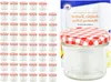 A set of small glass jars with red and white checkered lids, along with a booklet. Produktbild-Vorschau