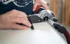 A person is using a Mafell edge milling machine on a white surface. Produktbild-Vorschau