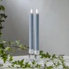 Two blue LED candles in clear glass holders, with ivy branches in the foreground. Produktbild-Vorschau