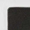 A close-up view of a textured black surface with a white background. Produktbild-Vorschau