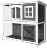 A two-story wooden rabbit hutch with wire mesh doors and windows. Voir les images du produit