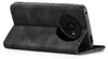 A black flip case for a smartphone, shown from the back with the camera module visible. Produktbild-Vorschau