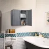 A bathroom scene with a wall-mounted cabinet, a ladder shelf, and a bathtub. Podgląd zdjęcia produktu