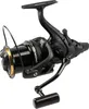 A black fishing reel with gold accents is shown against a white background. Náhled obrázku produktu