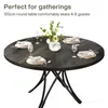 A round dining table set for a gathering with floral centerpiece and place settings. Anteprima dell’immagine prodotto