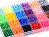 A clear, overhead view of a plastic organizer box filled with small, round beads in various colors. Náhľad obrázku produktu
