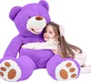 A young girl hugging a large purple teddy bear. Náhľad obrázku produktu