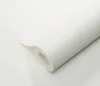A roll of white textured wallpaper is shown on a white surface. Náhľad obrázku produktu