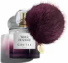 A bottle of perfume with a fluffy pom-pom attached. Anteprima dell’immagine prodotto