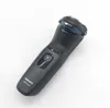A black electric shaver with blue accents is shown against a white background. Podgląd zdjęcia produktu