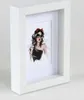 A white picture frame with a fashion illustration inside. Produktbild-Vorschau