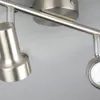 A close-up view of a modern track lighting fixture with two adjustable spotlights. Produktbild-Vorschau
