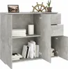 A grey concrete-effect sideboard with shelves and drawers, decorated with books, a vase, a framed picture and a ship's wheel. Produktbild-Vorschau