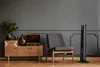 A living room scene with a vintage wooden cabinet, a chair, and a tall black fan. Podgląd zdjęcia produktu