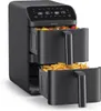 A black Brabantia double stack air fryer with two drawers, one containing vegetables and the other french fries. Produktbild-Vorschau