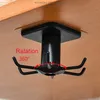A black rotating hook organizer is attached to the underside of a wooden surface, demonstrating its 360-degree rotation capability. Produktbild-Vorschau