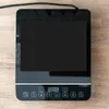 A black induction cooktop mat on a wooden surface. Náhľad obrázku produktu