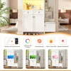 A white entryway furniture set with multiple cabinets and drawers, featuring integrated LED lighting and decorative elements. Below the main furniture, there are three distinct visual panels showcasing different lighting effects and features. Produktbild-Vorschau