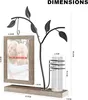 A product image showing a decorative picture frame with a glass vase and a metal tree, with dimensions indicated by text overlays. Produktbild-Vorschau